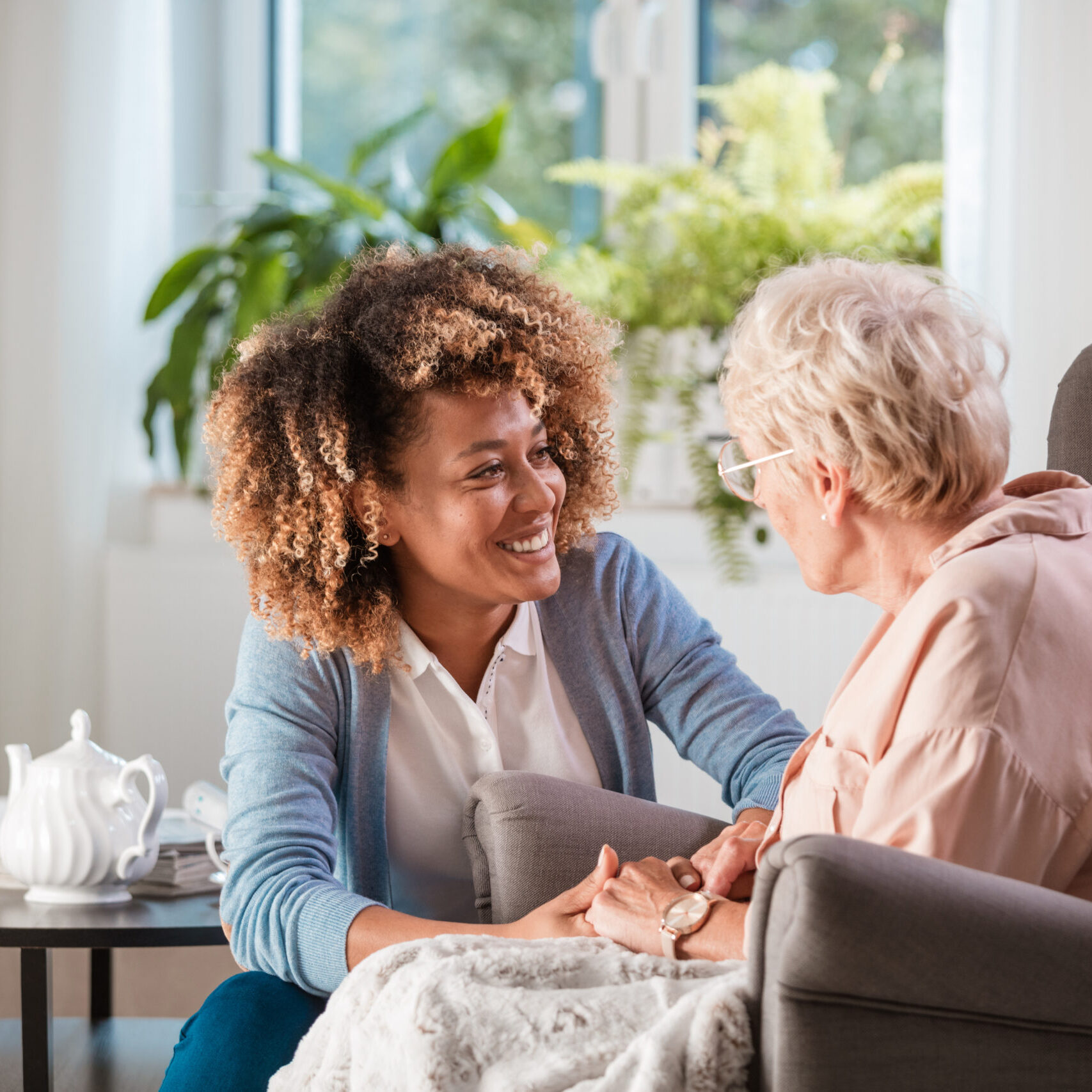 Friendly nurse supporting an eldery lady